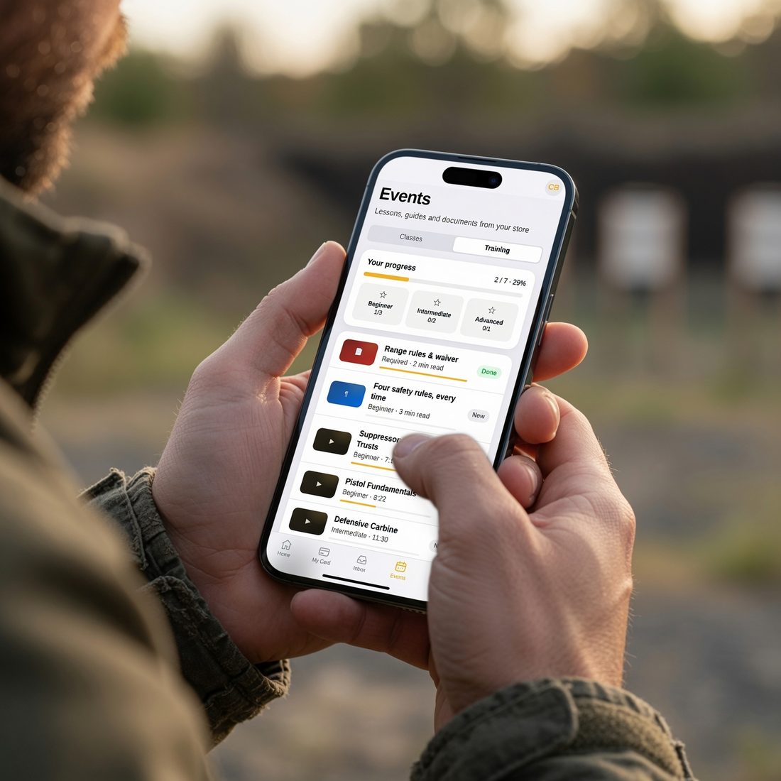 Range customer reading a TacApp safety lesson on a phone before shooting